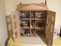 Front-opening view showing interior three levels and nine rooms with removable front panels