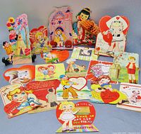 Full view of all 18 vintage Valentine cards arranged with visible die-cut shapes, pop-up elements and mechanical parts showing.