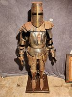 Front view of full suit of armor on wooden stand