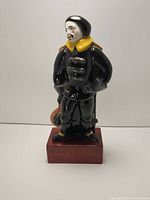 Front view of Nancy Mougin pottery figurine showing detailed face and clothing