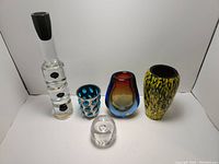 All five art glass pieces displayed in a row