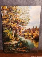 Full view of signed impressionist oil painting by Kun H Lee depicting autumnal riverside landscape.