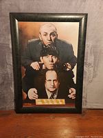 Front view of framed Three Stooges poster titled "Dewey, Cheatem and Howe, Attorney at Law"