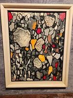 Full view of the framed abstract oil painting with textured elements and color palette.