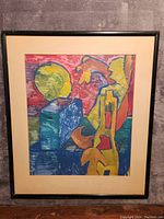 Frontal view of abstract painting in black frame with off-white mat