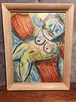 Front view of abstract oil painting in light wood frame