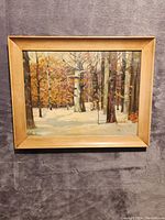 Front view of the oil painting showing winter forest scene with snow and trees in autumn colors.