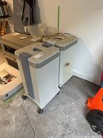 Two air purifiers side by side in garage