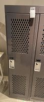 Metal locker front with perforated door and lockable handle, labeled with tag indicating lot 234.
