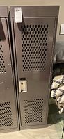 Full front view of gray metal locker with perforated ventilation holes in door, labeled with lot tag 236.