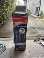 Front view of Honeywell tower fan box showing QuietSet and 8-speed settings.