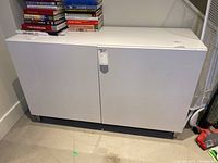 Cabinet front view showing white enamel finish and two doors closed.