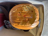 Large realistic orange pumpkin with detailed evil face carving