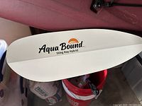 Close-up of Aqua Bound Sting Ray Hybrid white paddle blade and logo