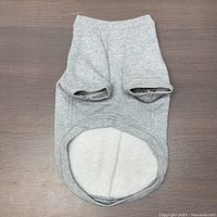 Top-down view of the gray cotton dog sweater showing the leg holes and rounded base.