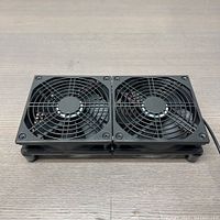 Top view of the laptop cooling stand showing two black fans with protective grills side by side on a rectangular base.