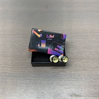 Photo showing the Luxed branded box with two LED bulbs placed next to it, highlighting the packaging and bulbs.