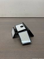 Front angle view of solar powered outdoor garden light showing black plastic body and LED panels.