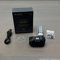 Photo of collar, accessories, and product box showing all included components for the system.