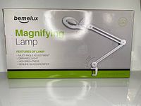 Front image of Bemelux Magnifying Lamp box showing lamp image, features including multi-angle adjustment, dimmable light, high brightness, genuine glass magnifier.