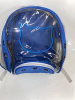 Front view of the blue cat backpack showing clear plastic bubble window shaped with cat head outline and mesh sides for ventilation.