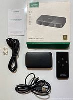 Overview of all items included: Ugreen HDMI switch, remote control, USB power cable, user manual, original box, and an additional cable.