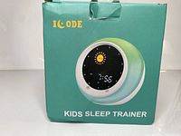 Front of the product box showing the Icode Kids Sleep Trainer device image and branding.