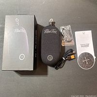 Full lot with the BlueTees PlayerGO speaker in protective case, box, USB charging cable, auxiliary cable, quick step guide, and instruction disc.