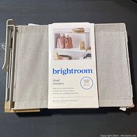 Brightroom shelf dividers packaged, beige fabric dividers with white metal sliding frames shown folded