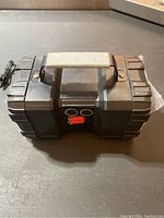 Side view of black rechargeable camping flashlight with handle, USB charging cable included.