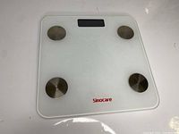 Top view showing the glass surface with four metallic BIA electrodes and Sinocare branding.