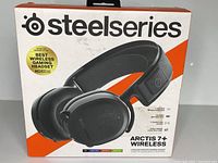 Front of the retail box showing SteelSeries branding and product image of the Arctis 7+ Wireless headset. Highlights features: best wireless gaming headset from PC Gamer, lossless 2.4GHz wireless, 30 hour battery life, SteelFrame construction.