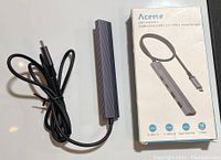 Aceele USB-C Hub alongside its original packaging box showing front and cable.