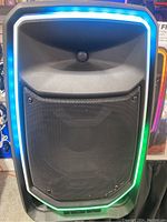 Front view of the speaker with illuminated RGB LED light ring around the grille showing the lighting feature.
