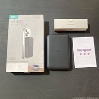 Top view of ESR wireless power bank with original box, accessories box, and user guide laid out on a flat surface.