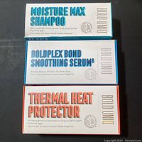 Three Bold Uniq hair products stacked: Moisture Max Shampoo, Boldplex Bond Smoothing Serum, Thermal Heat Protector in white boxes with colored text.
