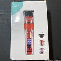 Box showing image of the transparent red electric pet grooming clipper with digital display and controls