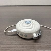 Front-side view of Dreamegg HFD-W11 Max white noise machine showing perforated speaker top and power button.