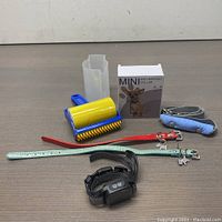 Full view of all items including mini anti-barking collar, dog collars, leash, and lint roller