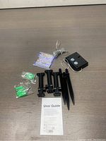 All items included in the lot laid out on a table. Fairy lights, stakes, wall plugs, solar panel control unit, and user guide visible.
