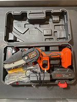 Mini chainsaw in carrying case with battery and accessories