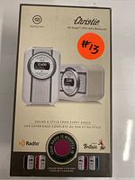 Front of the boxed Christie HD Radio FM showing brand, NFC, Bluetooth features, and available colors.