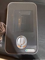 Top view of the Germ Guardian air purifier showing the perforated grille and the round control dial with UV light setting and brand label.