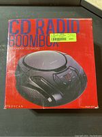 Original retail box of Proscan CD Radio Boombox, red with image of boombox on front and product branding.