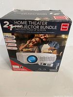 Box of RCA Home Theater Projector Bundle showing branding and main features