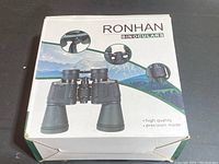 Box packaging of Ronhan binoculars showing product image and brand name.