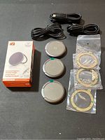 Three IQ Kickstand Magnetic Wireless Chargers with three USB cables and three magnetic rings in plastic bags, one product box.