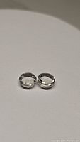 Two round green amethyst gemstones with checkerboard cut on white background