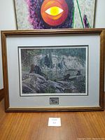 Framed print titled "Living on the Edge" by Paul Rankin showing the full framed artwork on a table.