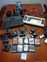 Overview of both game consoles, controllers, games, and power supply laid out on table